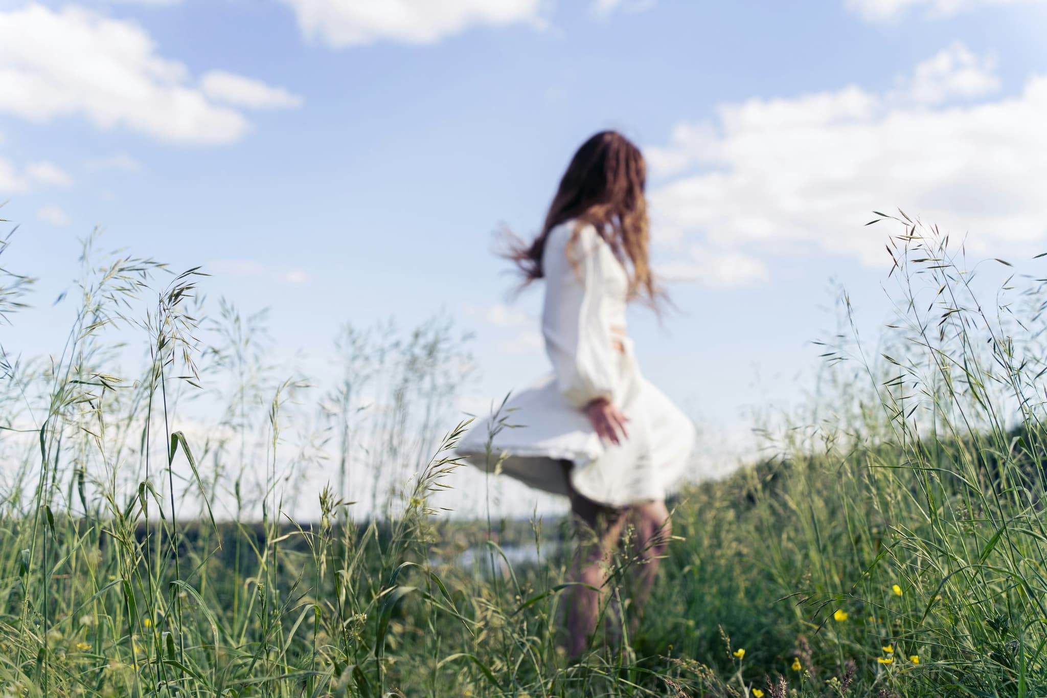 Woman looking out at an open sky, warm evening light